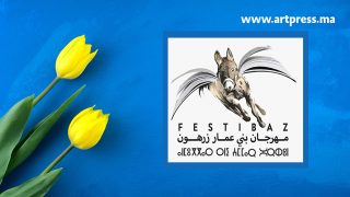 Yellow tulip flowers flat lay on handmade bright blue ocean grunge abstract acrylic texture background.